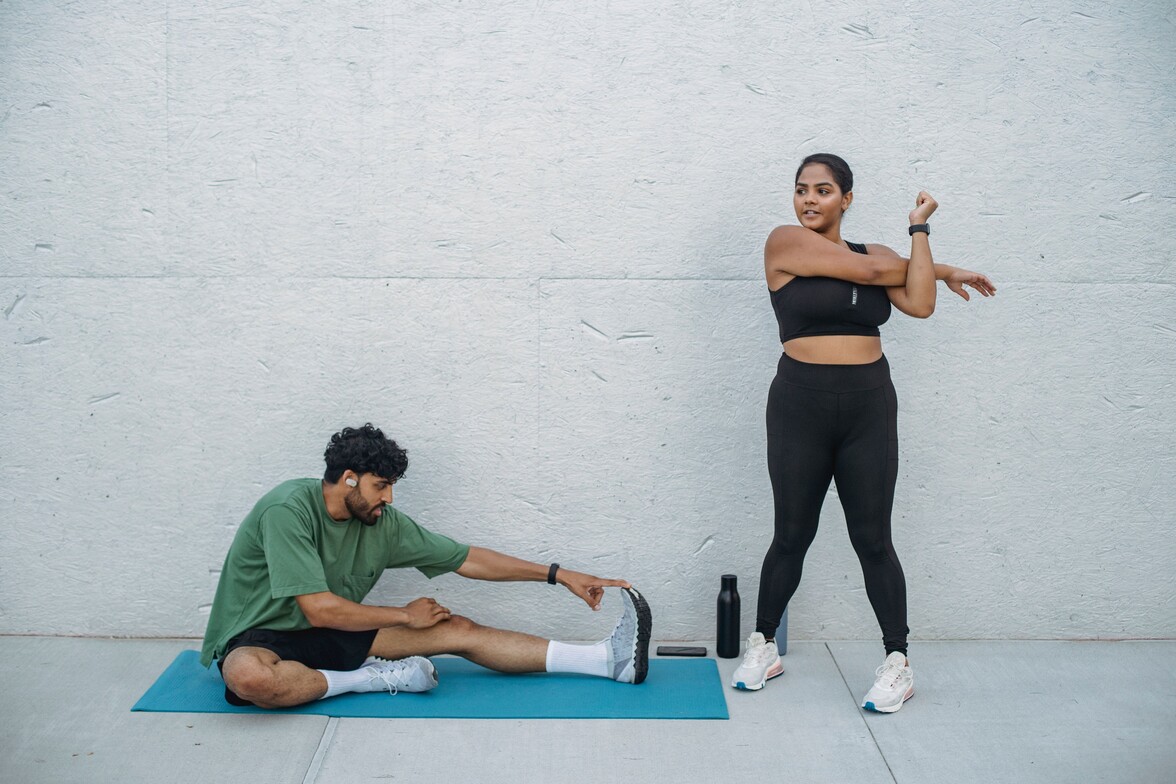 image of two people stretching