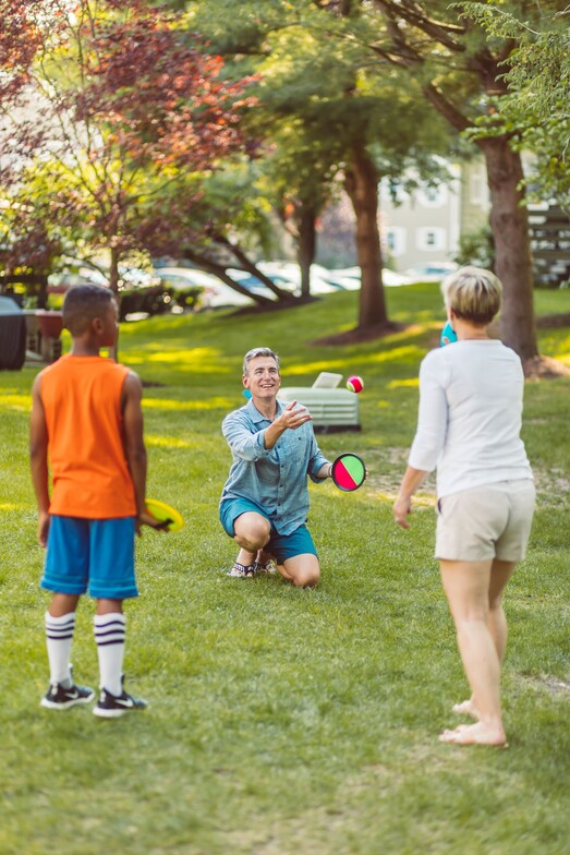 a family playing a game in a park