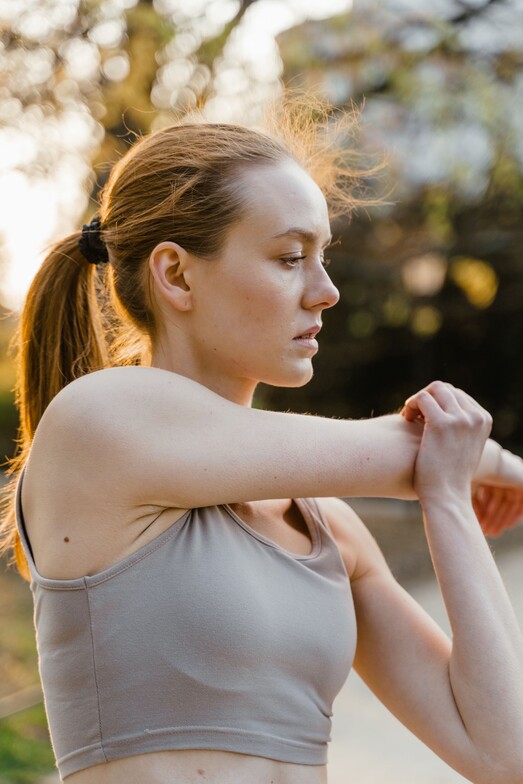 image of person stretching shoulder